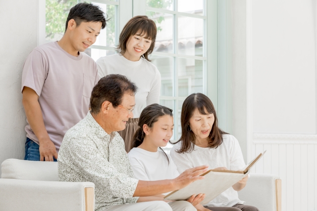 アルバムを見ている家族の写真